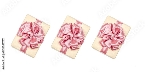 Eco-friendly gift boxes wrapped in kraft paper and decorated with satin ribbons isolated on white