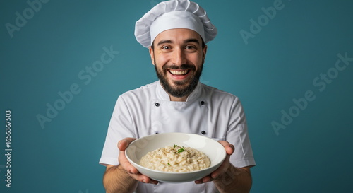 Smiling Chef Presenting Delicious Risotto Dish