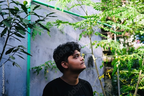Portrait of a young man in a garden