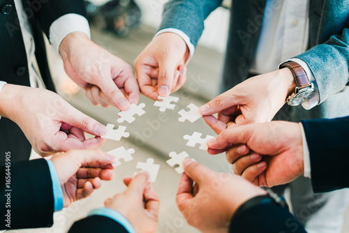 business concept shown through a jigsaw puzzle, where each piece connects to build strategy teamwork and success in the corporate.
