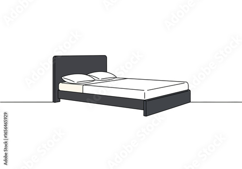 A bed with two pillows and a dark gray frame resting on a white surface
