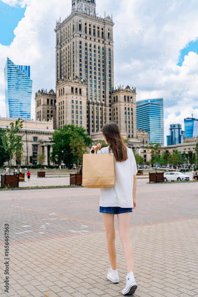 Woman Walking with Shopping Bag in City Center Woman Walking with Shopping Bag in City Center