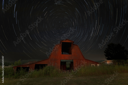 Old Red Barn at night with star trails of Polaris the North Star