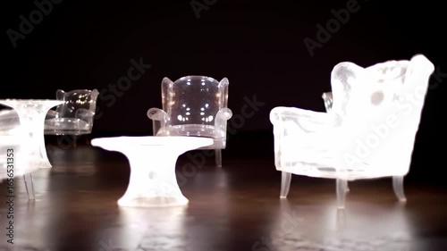 Transparent illuminated furniture collection in dark setting for interior design inspiration