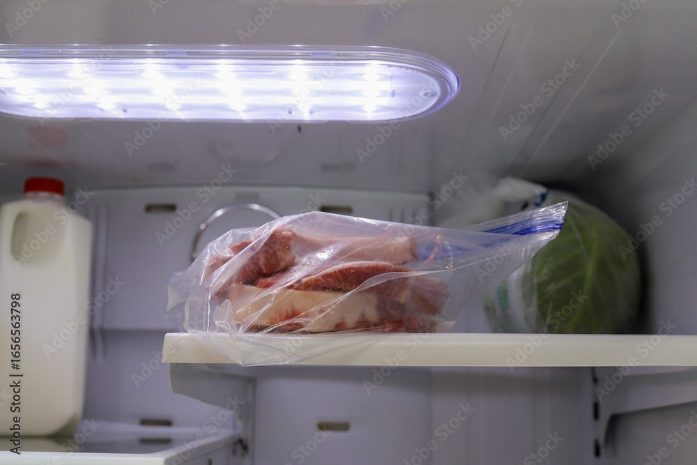 Ταπετσαρία A bag of frozen pork chops thawing in a refrigerator
