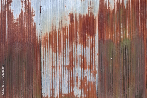 Rusty metal roof. Vintage style metal sheet roof texture. Pattern of old metal sheet. Rusting metal or siding. Corrosion of galvanized. Background and texture in retro concept
