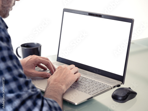 person working on laptop computer with blank transparent screen at home