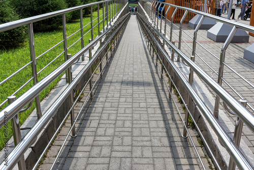 Wheelchair ramp with handrails. Accessibility and architecture