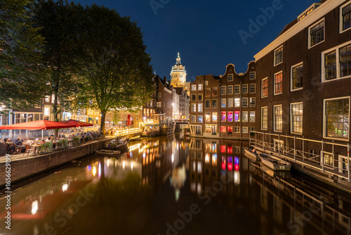 Amsterdam by night in the Netherlands, with canals, lights, reflections int the water