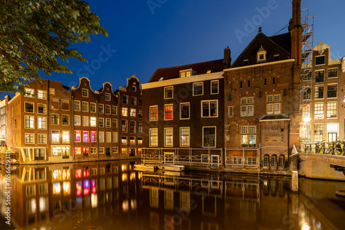 Amsterdam by night in the Netherlands, with canals, lights, reflections int the water