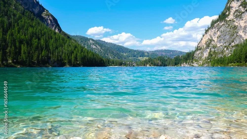 Lake Braies, Dolomites, Italy. Summer panoramic of the turquoise and crystalline water with the mountain landscape.
