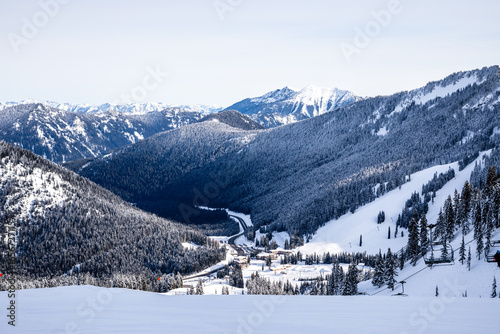 Snowy Alpine Ski Resort: Tranquil Mountain Scene with Snow-Capped Peaks, Ski Lift, and Sunset