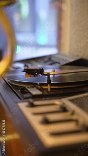 The footage showcases a vintage vinyl record player spinning a classic record, beautifully capturing the nostalgia and warmth of analog music in a modern setting, fa01