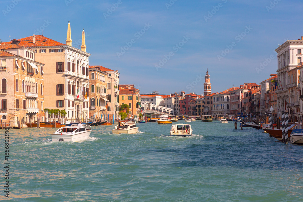 Obraz premium Traditional Venetian canal house with balconies and moored boat on Grand Canal in Venice Italy