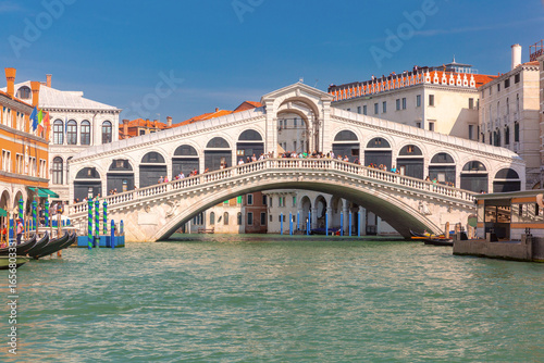 Rialto Bridge over Grand Canal with gondolas and historic buildings in Venice Italy