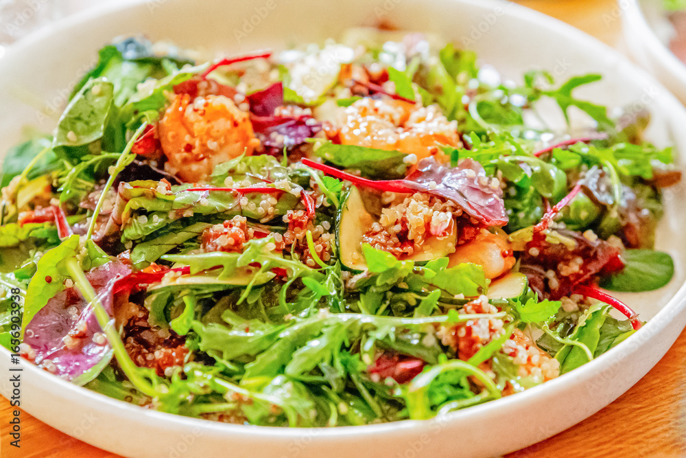 Shrimp salad with various vegetables, close-up on a wooden dining table Shrimp salad with various vegetables, close-up on a wooden dining table