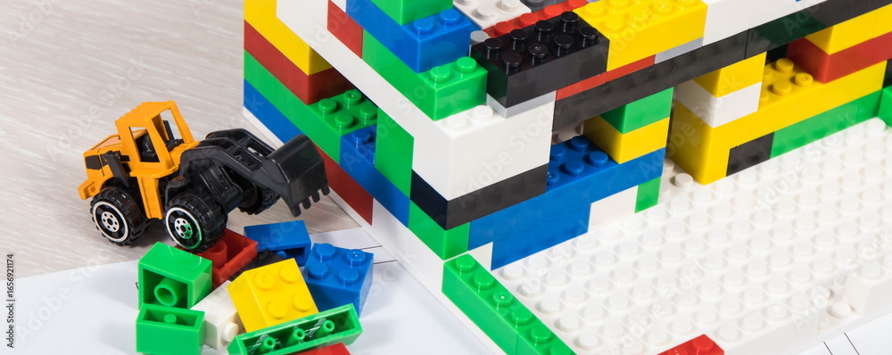 Obraz premium Housing plan with electric installation, house under construction made of toy blocks. Subject of building or renting home