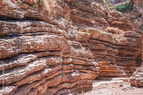 rocky canyon wall made of sandstone layers
