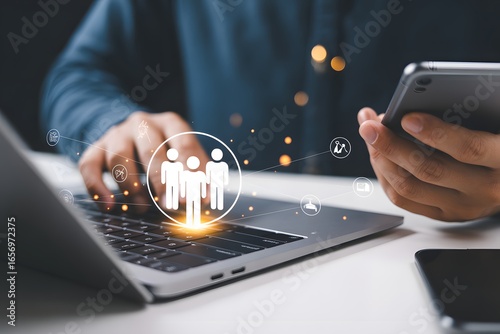 Digitization of workforce: A person is using laptop and mobile phone, the visualization of work environment is visible in this image.