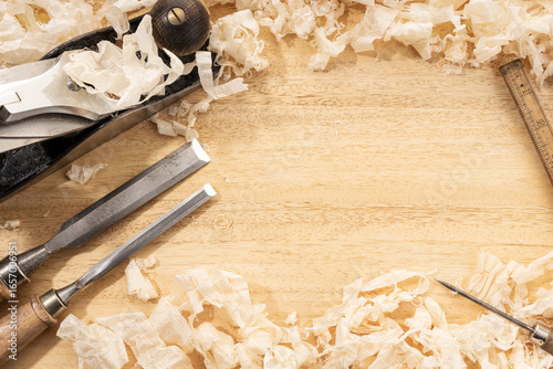 Carpentry or woodworking background with copy space. Old carpentry tools and wood shavings on a workbench