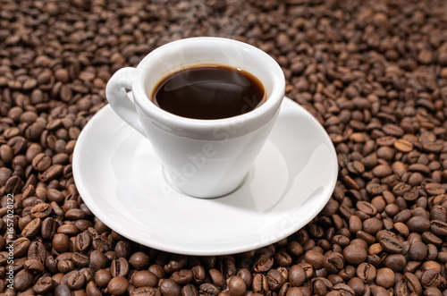 Espresso Coffee cup on roasted beans background