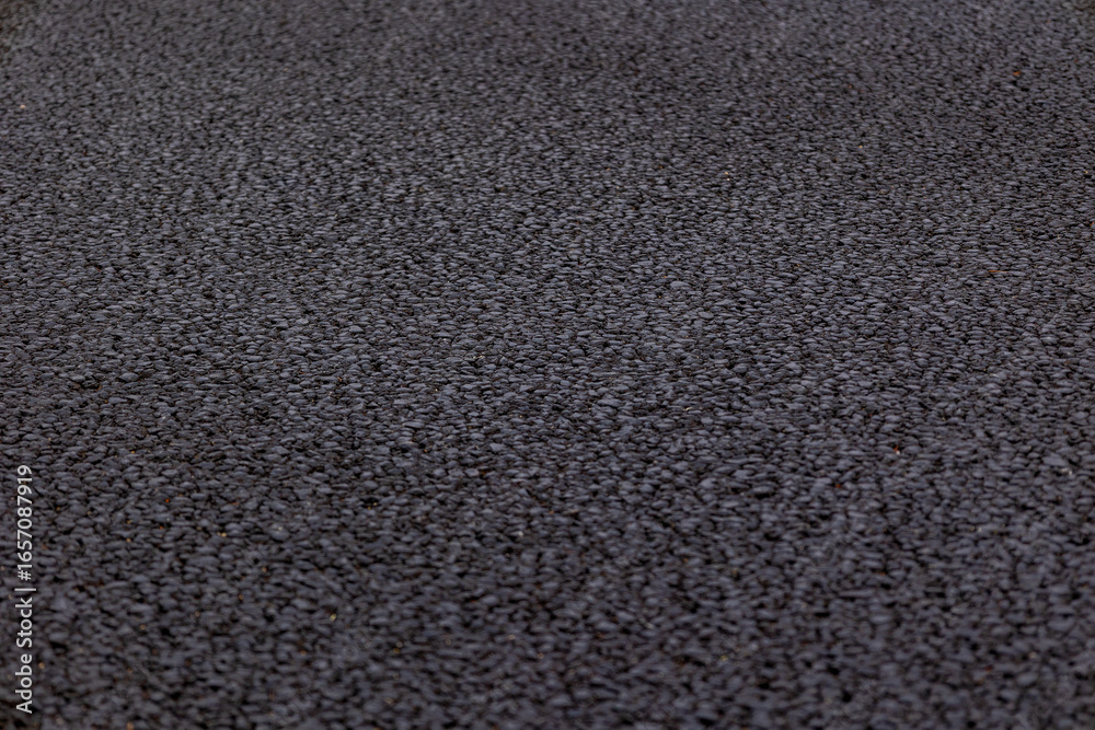 Fototapeta premium Industrial concrete surface close-up, capturing grit, wear, and weathered patterns in high resolution.