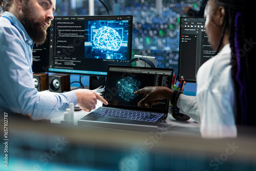 Wall Mural Team leader teaching intern to code in data center, updating AI automation scripts