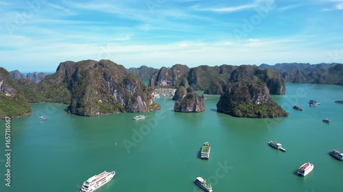 Ha Long Bay, Vietnam: Breathtaking aerial drone flight over Hạ Long Bay, panoramic view of iconic limestone karsts in emerald water - UNESCO landscape panorama of Southeast Asia from above
