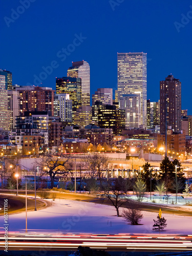Downtown Denver high-rises lit up at dusk in winter