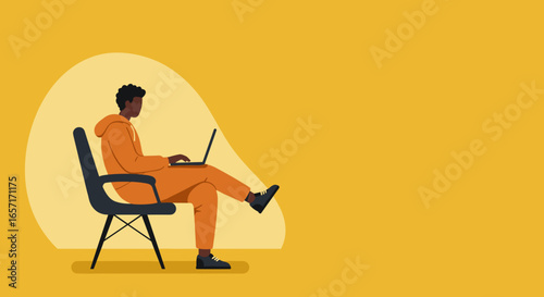 Young African American man casually working or studying remotely on a laptop, embodying modern digital lifestyle and online productivity.