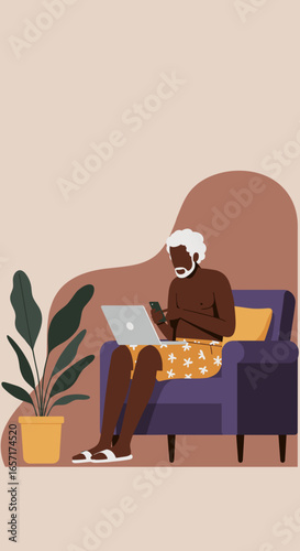 Senior man enjoys leisure, working remotely with laptop and phone from a comfortable armchair at home. Digital lifestyle.