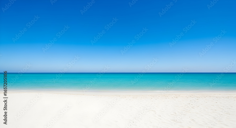 Obraz premium Vast expanse of bright blue sky meeting turquoise ocean water with a foreground of clean white sand