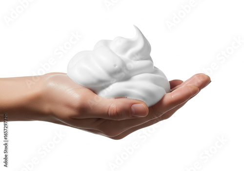 Hand holding fluffy white cosmetic foam against a clean white background