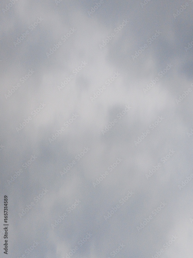 Soft gray clouds filling the sky creating a serene and peaceful atmosphere Soft gray clouds filling the sky creating a serene and peaceful atmosphere