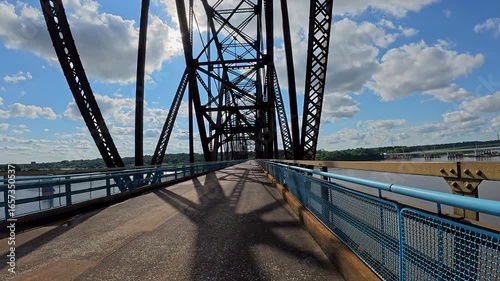 POV cycling across the historic Old Chain of Rocks Bridge (Route 66) over the Mississippi River near St. Louis, Missouri. Scenic ride with sweeping river views, unique bridge design.