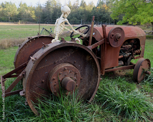 Halloween character driving tractor on farm field