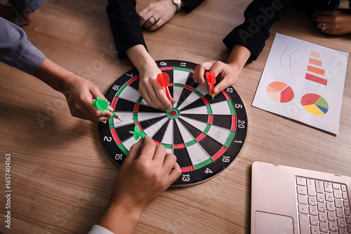 Business team pointing to a darts aiming at the target center business,Targeting the business concept