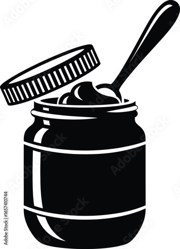 An open jar of peanut butter with a spoon, showcasing a creamy and delicious spread for sandwiches or snacks