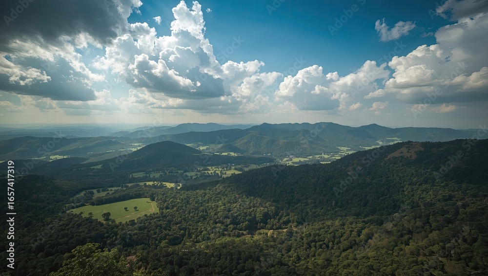 Obraz premium Expansive vista of a mountainous landscape under a dramatic sky.