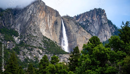 Majestic Yosemite Falls cascading down granite cliffs amid lush greenery