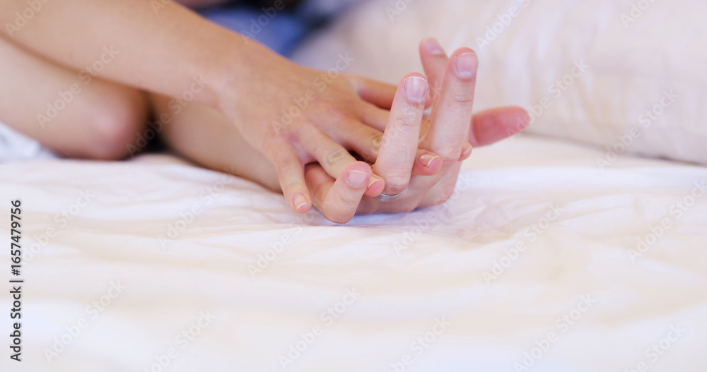 Naklejka premium Couple, holding hands and relax with comfort in bed for love, support or trust together in home. Closeup, people or touch with commitment for relationship, physical connection or bonding on space