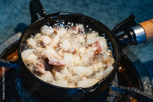 rander lard with small black iron pan