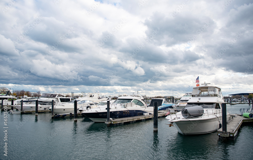 Fototapeta premium Yacht charter. Sea vacation on summer. Luxury boat motor yacht in marina. Luxury yacht docked in marina sea. Boating and yachting tourism. Luxurious lifestyle. Summer vacation