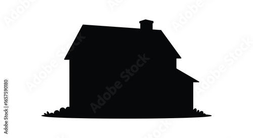A black silhouette of a house with a chimney and grass