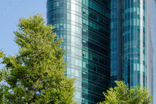 modern glass building with blue sky and green trees in Urban city 