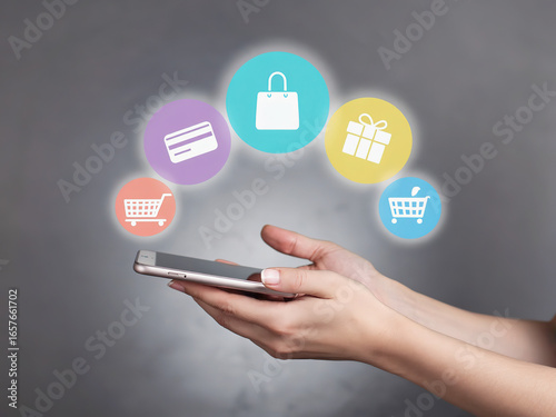 Wallpaper Mural “Hands Holding Smartphone with Shopping Icons – Online Shopping and Mobile Commerce Concept” Torontodigital.ca