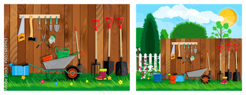 Garden tools set with wheelbarrow, shovel, rake, and watering can near wooden fence. Gardening accessories for spring and summer.