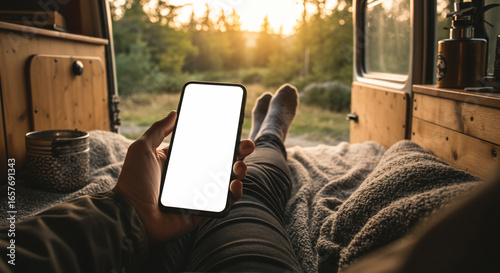 Relaxing in Camper Van, Holding Smartphone with Blank Screen at Sunset
