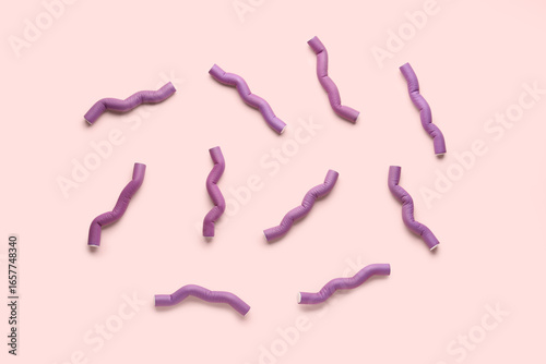 Hair curlers on pink backgr...