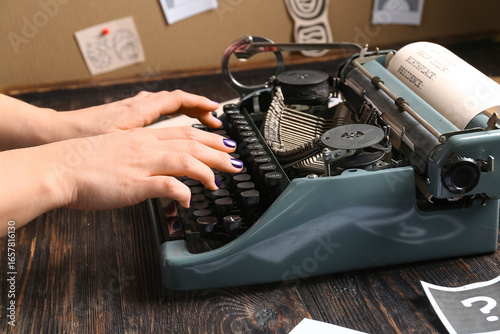 Woman typing on retro typew...